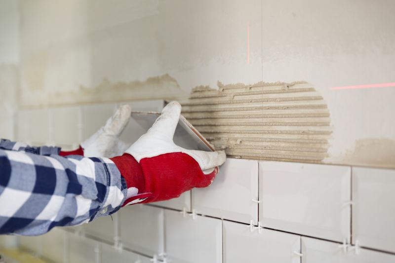 Tile professionals working on a kitchen backsplash